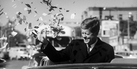 Candidate Kennedy is sprayed with confetti as his motorcade drives through Illinois.
