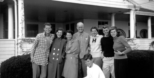 The Kennedy Family in Hyannis Port, 1948. L-R: John F. Kennedy, Jean Kennedy, Rose Kennedy, Joseph P. Kennedy Sr., Patricia Kennedy, Robert F. Kennedy, Eunice Kennedy, and in foreground, Edward M. Kennedy. Photograph in the John F. Kennedy Presidential Library and Museum, Boston.