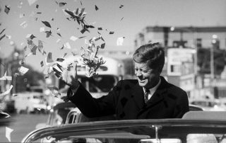 Candidate Kennedy is sprayed with confetti as his motorcade drives through Illinois.