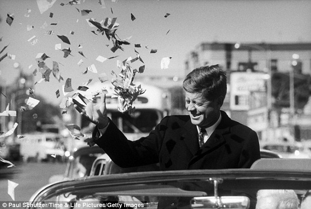 Candidate Kennedy is sprayed with confetti as his motorcade drives through Illinois.